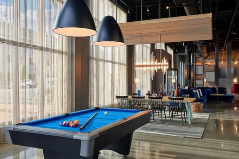 Unwind with a friendly game under warm designer lighting.