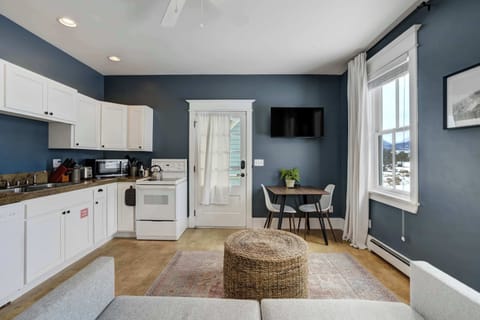 The studio’s open layout combines the full kitchen, dining nook, and living space into one bright, functional area. Clean cabinetry and natural light keep the room feeling fresh and welcoming.