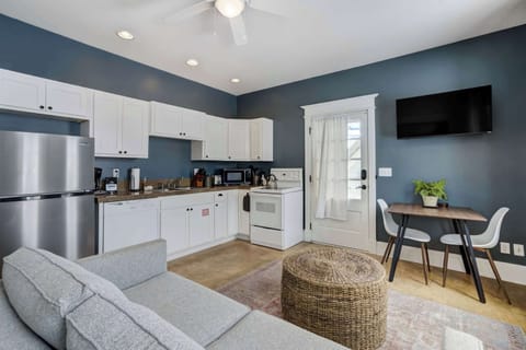 The studio’s open layout brings the kitchen, dining nook, and living area together for a smooth, functional flow. Stainless appliances and clean cabinetry keep the space fresh and modern.