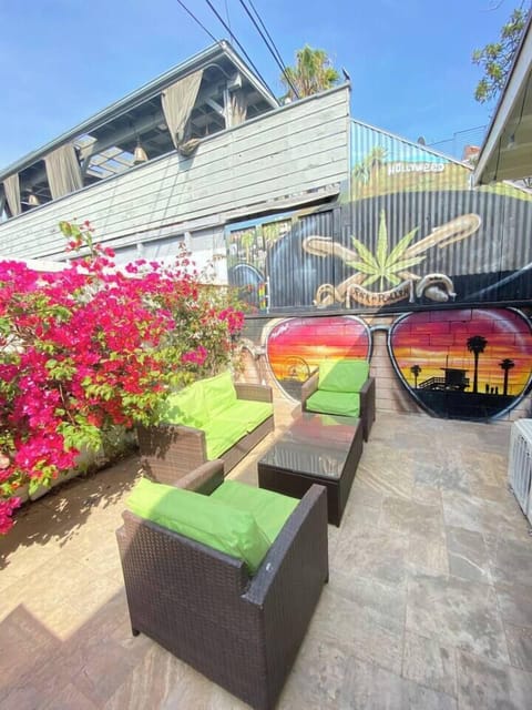 Private outdoor lounge surrounded by vibrant flowers and custom mural art.