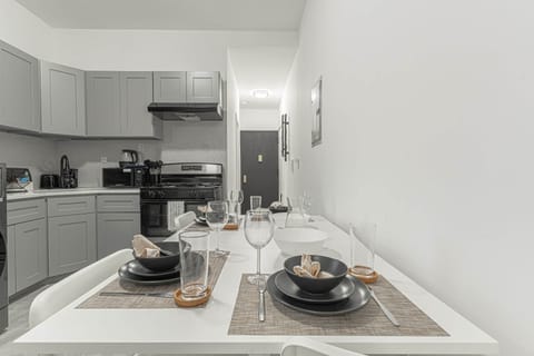 Modern kitchen with sleek appliances and a stylish table set for four