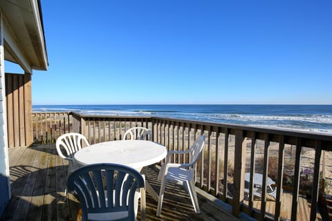 Enjoy breathtaking oceanfront views from the spacious balcony, complete with a dining table perfect for morning coffee in Duck, North Carolina.