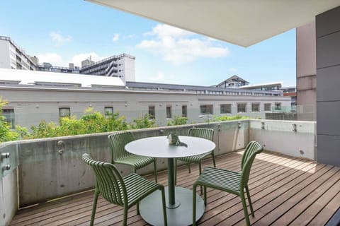 Start your morning or wind down in the evening on the first leafy balcony with a café-style table—perfect for coffee or wine.