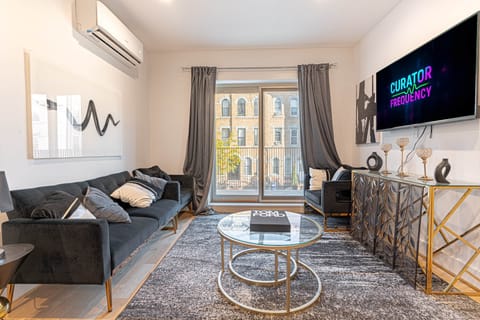 Bright living area featuring Japandi design, comfy sofa, smart TV and direct access to balcony