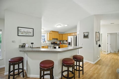 Bar seating at the kitchen, open to the living aream keeping everyone connected.