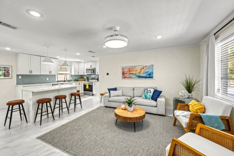 The spacious, sunlit living area encourages complete relaxation, providing a comfortable coastal setting.