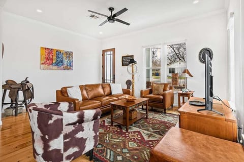 Living Room with Leather Sofas, TV, and Country Decor