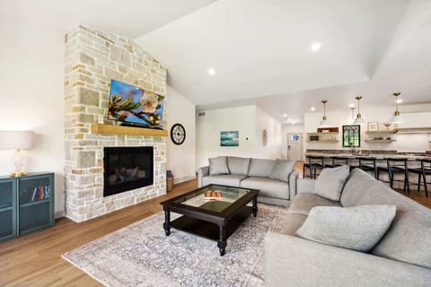 The cozy living room is centered around plush seating and a Smart TV, perfect for movie nights, morning cartoons, or rainy-day board games.