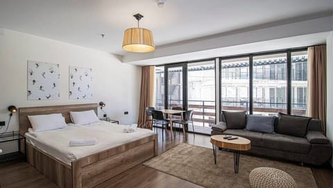 The living area features comfy sofas and a plush carpet for a warm, homey vibe.