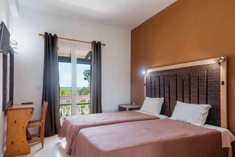 Bright, comfortable bedroom with direct balcony access.