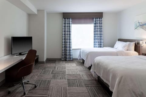 Stretch out in bright comfort with plush beds and workspace.