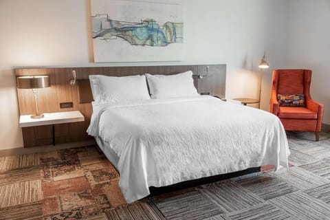 Relax into a plush king bed with soft, hotel-style bedding.