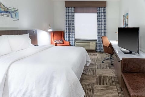 Unwind in a bright king room with workspace and views.