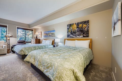 Unwind in this serene bedroom where mountain vistas greet you each morning through expansive windows. Crisp linens and nature-inspired artwork create your perfect alpine retreat.