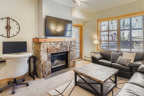 Living Room, plenty of seating, fireplace, desk for work area