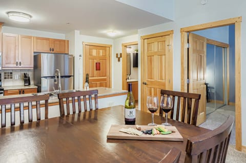 Dining table, view towards front door, bathroom, and bedroom