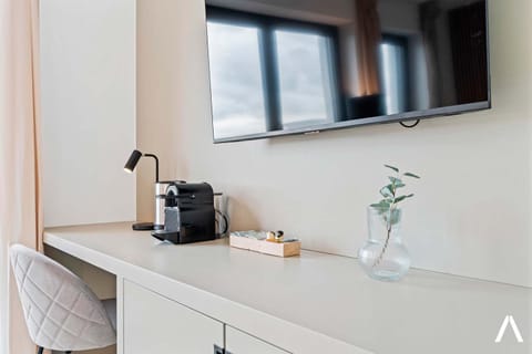  Desk space with a coffee maker and kettle for added convenience.