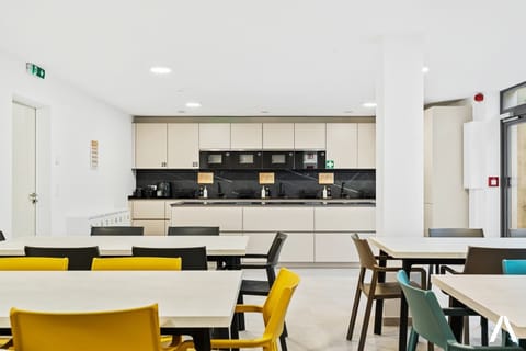 Shared Dining Area – Enjoy meals or gatherings in this chic dining space with comfortable seating for all residents.