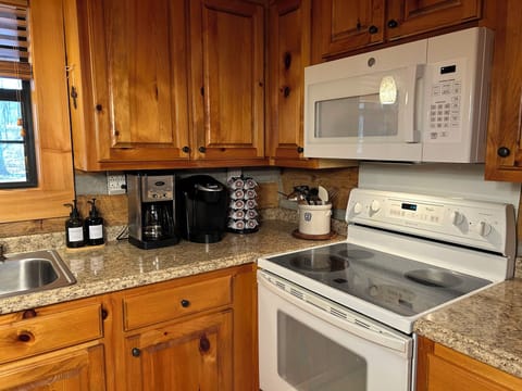 Kitchen with dish soap, coffee maker, Keurig, K-cups, oil, and salt and pepper
