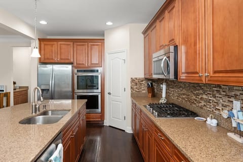Kitchen with stainless steel appliances and gas range.