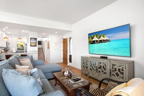 Not staged. Not posed. Just light-flooded ease where bare feet, book spines, and wine corks belong. KRV-2823