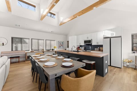 Spacious dining table with extensions available to host up to 14 guests—perfect for large gatherings.