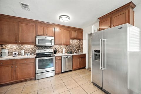 Warm kitchen w/ wood cabinets & space to prep your fave meals