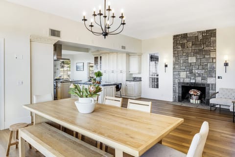 Large dining area featuring a wooden table and chandelier.