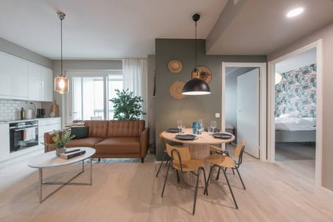 This bright Helsinki home offers an open feel with a seamless flow between the sofa, modern kitchen, and inviting dining area. Large windows lead to a private balcony, while the stylish bedrooms promise restful nights.
