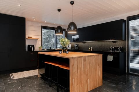 The modern, fully equipped kitchen offers high-quality appliances and plenty of workspace, making cooking effortless. The adjoining dining area provides room for shared meals and cozy table gatherings.