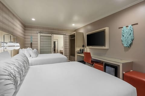 Unwind together in a spacious room with two plush queens.