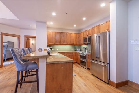 Picture yourself preparing meals while friends gather at the breakfast bar.