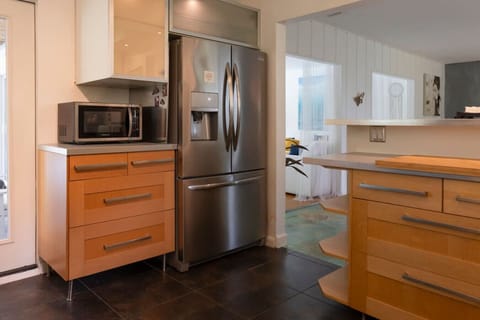 Modern fully equipped kitchen with stainless steel appliances, gas stove, and all cooking essentials.