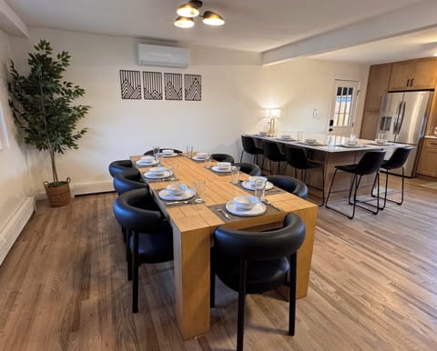 Large dining table comfortably seats 8, paired with the island seating for 5