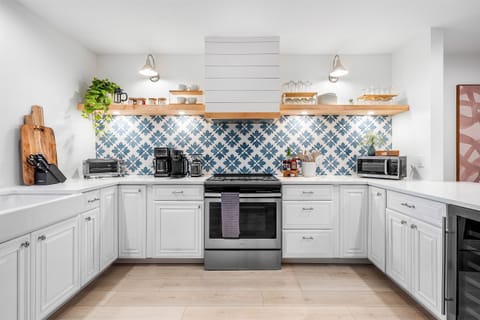 A chef's dream! This beautifully designed kitchen boasts gleaming countertops, a farmhouse sink, and all the tools you need to prepare delicious meals.