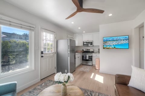 Sunlit living area seamlessly connects to kitchen.
