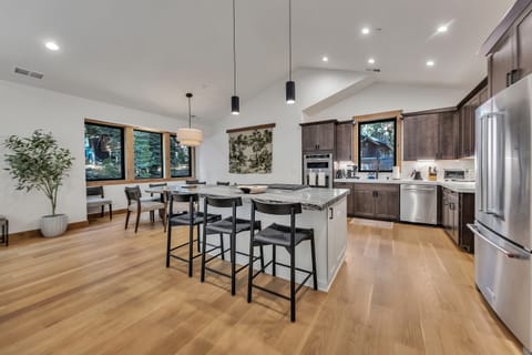 Open kitchen and dining area with bar seating for 3.