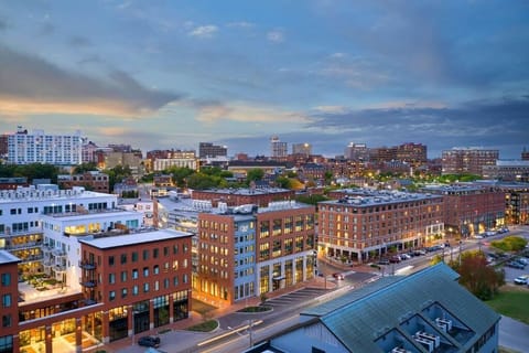 Arrive to a vibrant cityscape glowing at sunset.