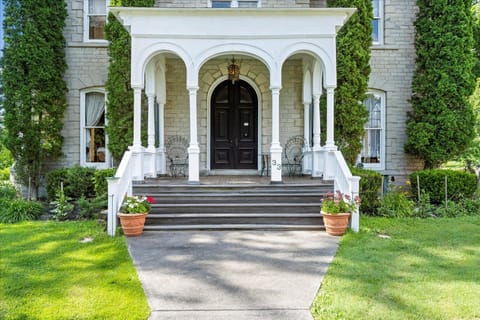 Welcoming you with classic elegance—step through the front archway into a beautifully preserved 1800s manor.