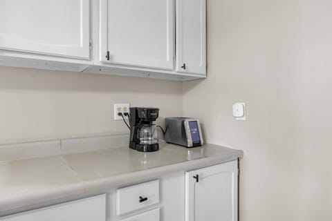Start your mornings right with your personal coffee station featuring a drip coffee maker and toaster, perfectly positioned for easy access.