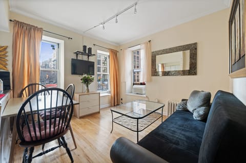 Your bright city retreat features comfy seating, natural light, and stylish décor for the perfect urban getaway.