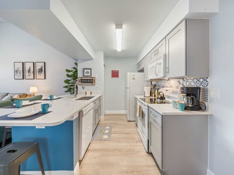 This beautifully updated kitchen blends sleek cabinetry, quartz countertops, and contemporary design to create a stylish culinary space. Fully equipped with modern appliances, ample prep areas, and a spacious breakfast bar, it’s perfect for effortless cook