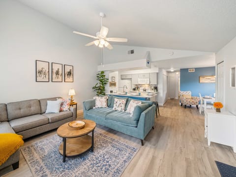 The seamless flow between the living room, dining area, and kitchen creates a bright, airy space designed for connection and comfort.