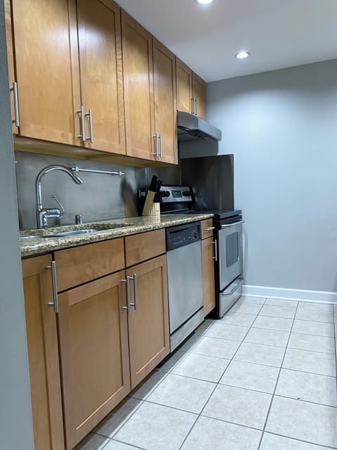Full kitchen with full sized range, dishwasher, refrigerator, and microwave