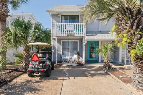 Front exterior of the house with golf cart.