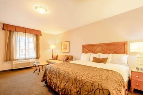 Unwind in a bright king room with cozy seating nook.