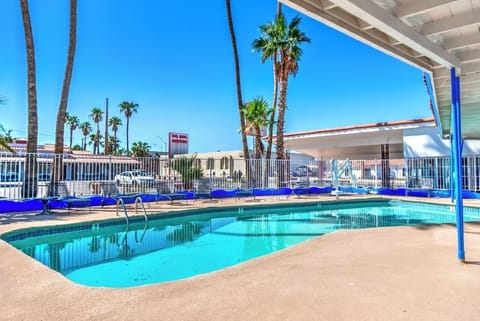 Dive into sunshine beside sparkling pool and swaying palms.