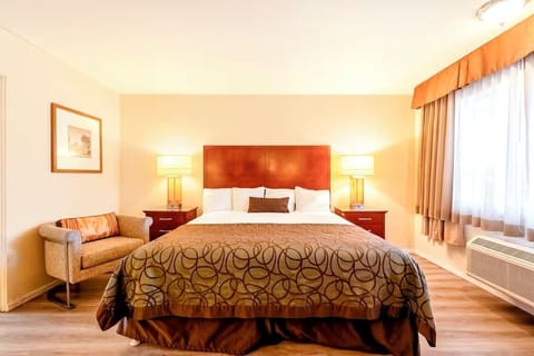 Unwind in a bright king room with cozy seating.