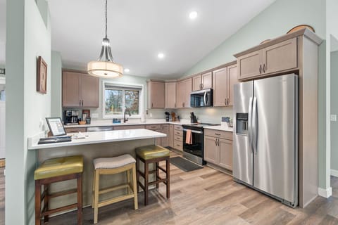 Your fully equipped kitchen awaits with stainless steel appliances, quartz countertops, and a breakfast bar perfect for morning coffee.
