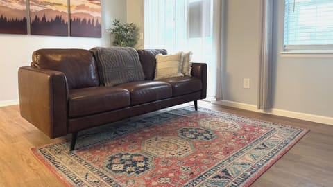 Sink into this luxurious leather sofa and let the warm afternoon light streaming through your windows create the perfect atmosphere for relaxation. The rich textures and thoughtful decor make this your ideal retreat.